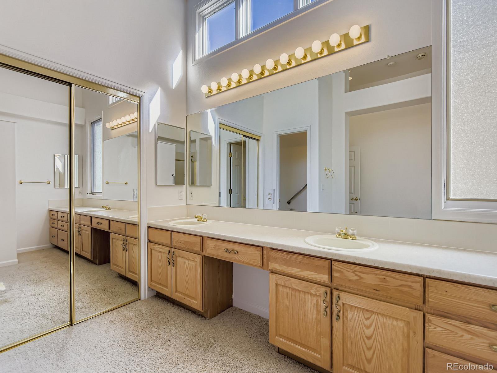 5418 Shetland Court Highlands Ranch, CO 80130 - Photo 13 of 23 a spacious bathroom with a granite countertop double vanity sink and a mirror