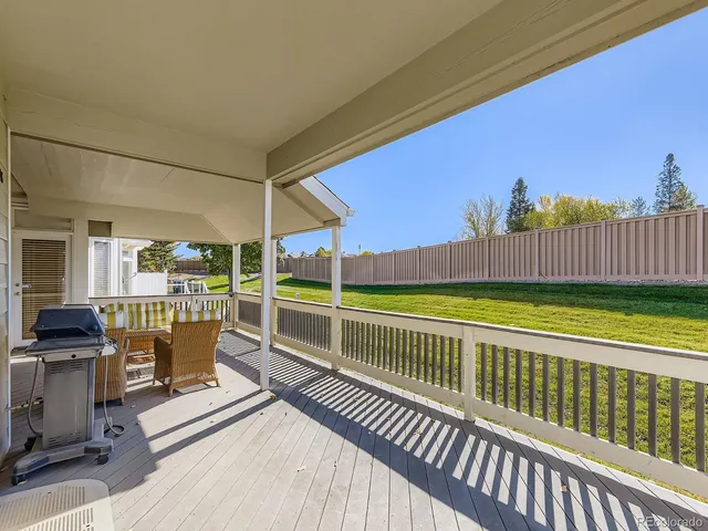 a view of a balcony with a floor to ceiling window and wooden fence