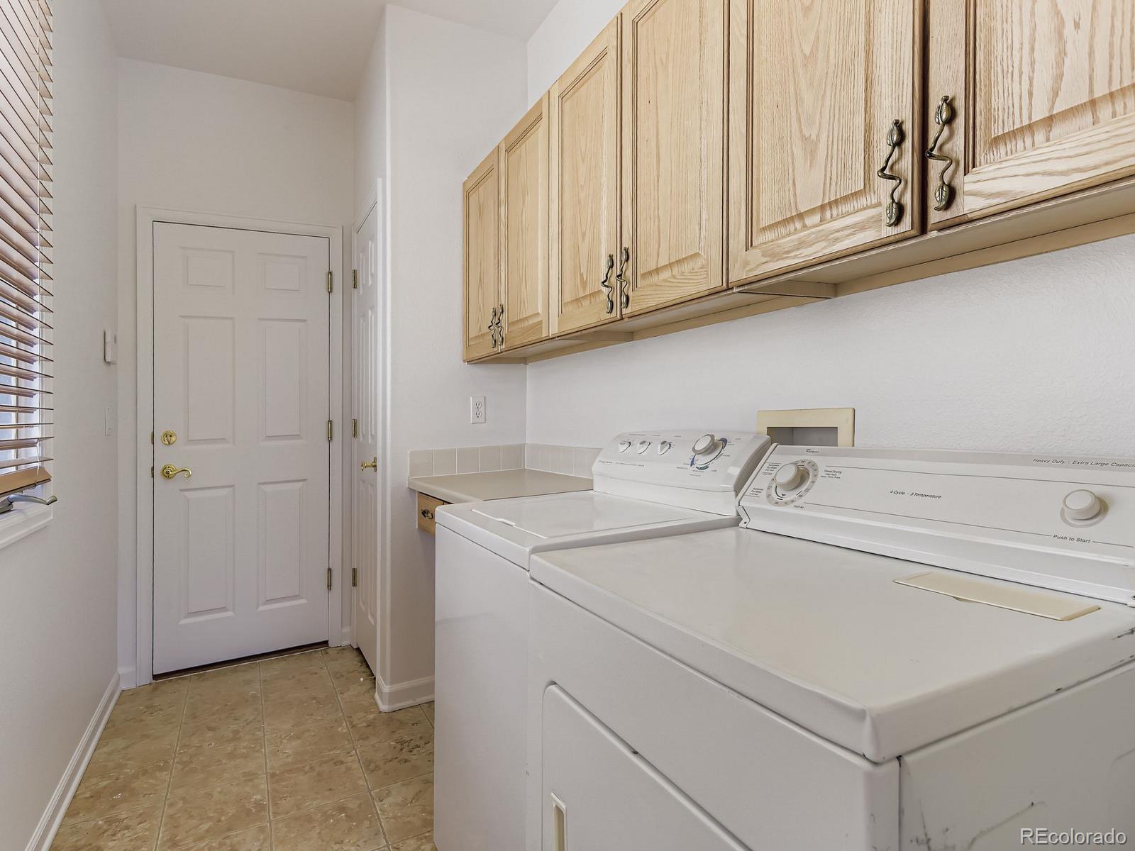 5418 Shetland Court Highlands Ranch, CO 80130 - Photo 16 of 23 a utility room with dryer and washer