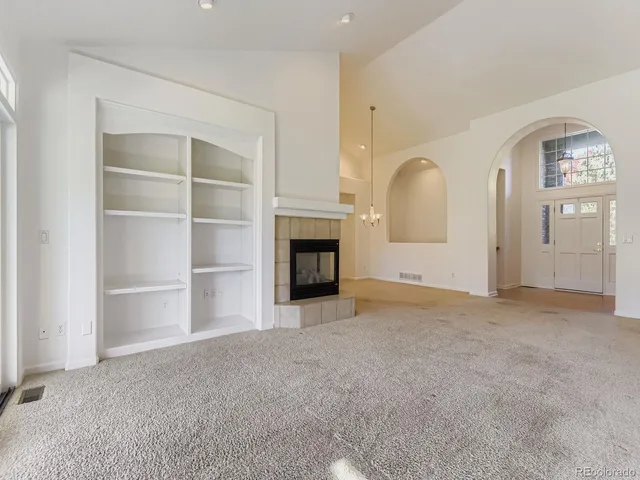 a view of a livingroom with an empty space and a fireplace
