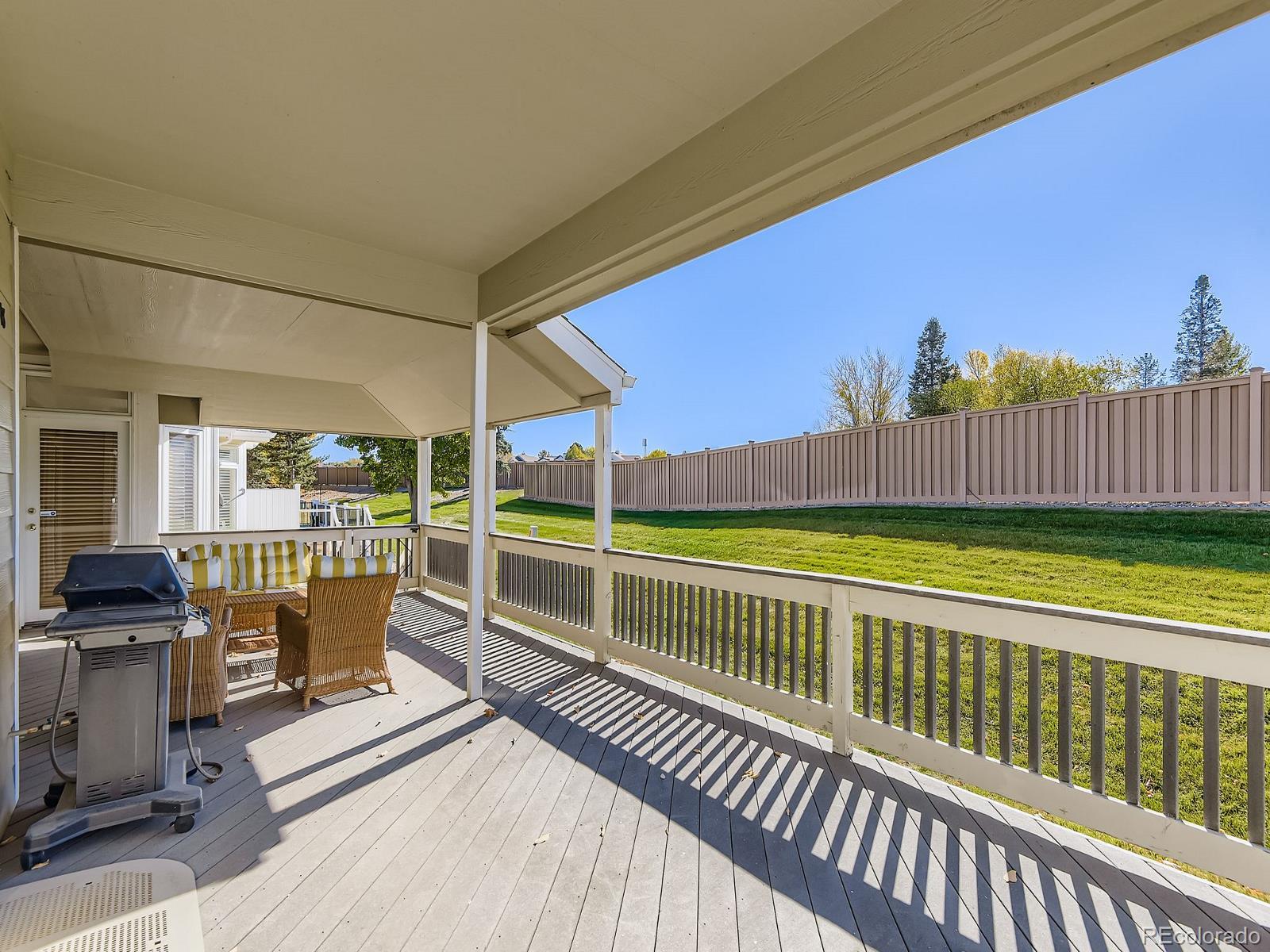 5418 Shetland Court Highlands Ranch, CO 80130 - Photo 3 of 23 a view of a balcony with a floor to ceiling window and wooden fence