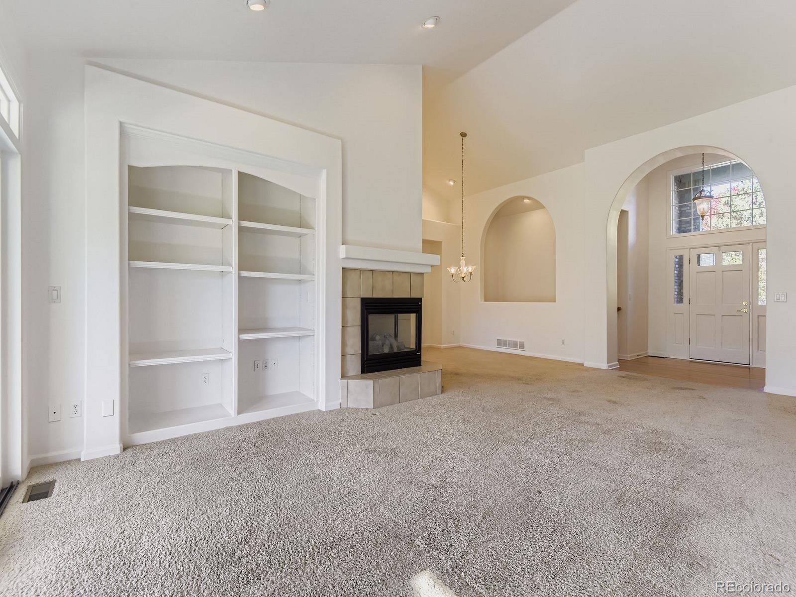 5418 Shetland Court Highlands Ranch, CO 80130 - Photo 5 of 23 a view of a livingroom with an empty space and a fireplace