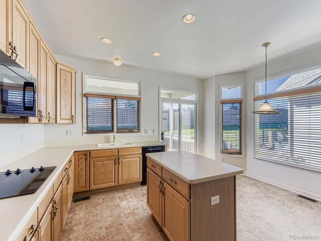 a kitchen with counter top space sink and stainless steel appliances