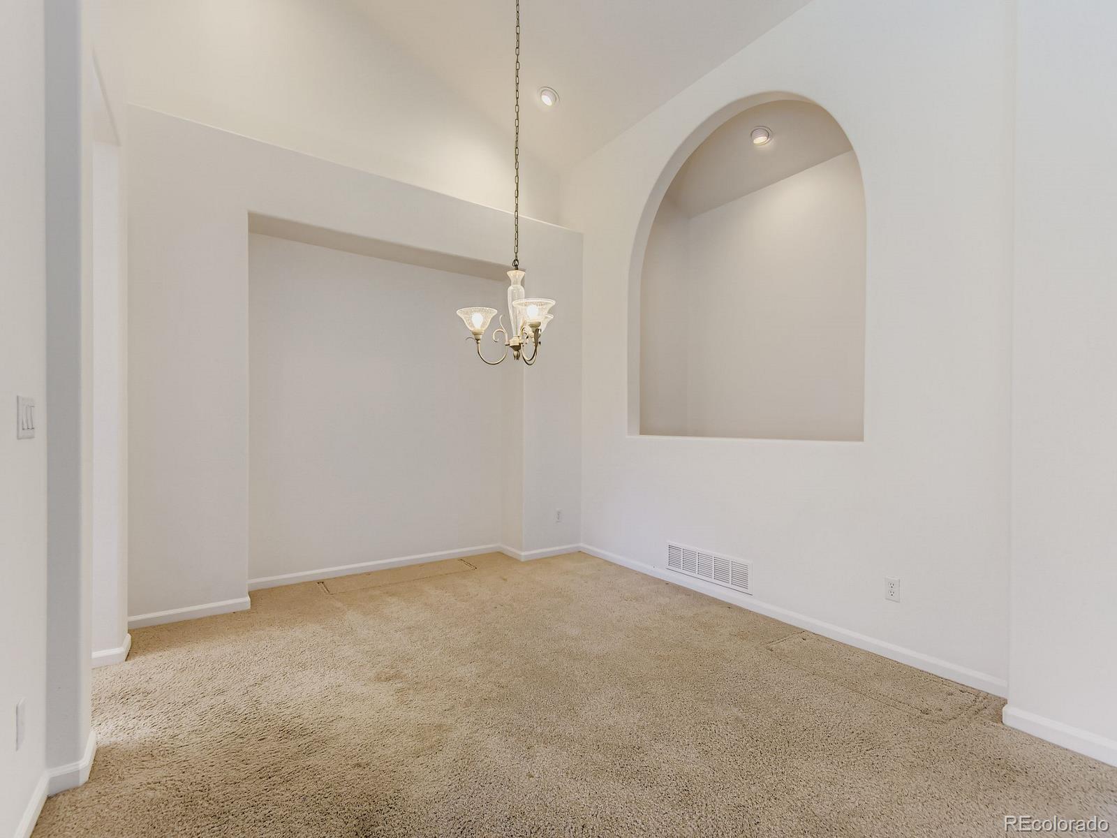 5418 Shetland Court Highlands Ranch, CO 80130 - Photo 9 of 23 an empty room with a mirror and a fan