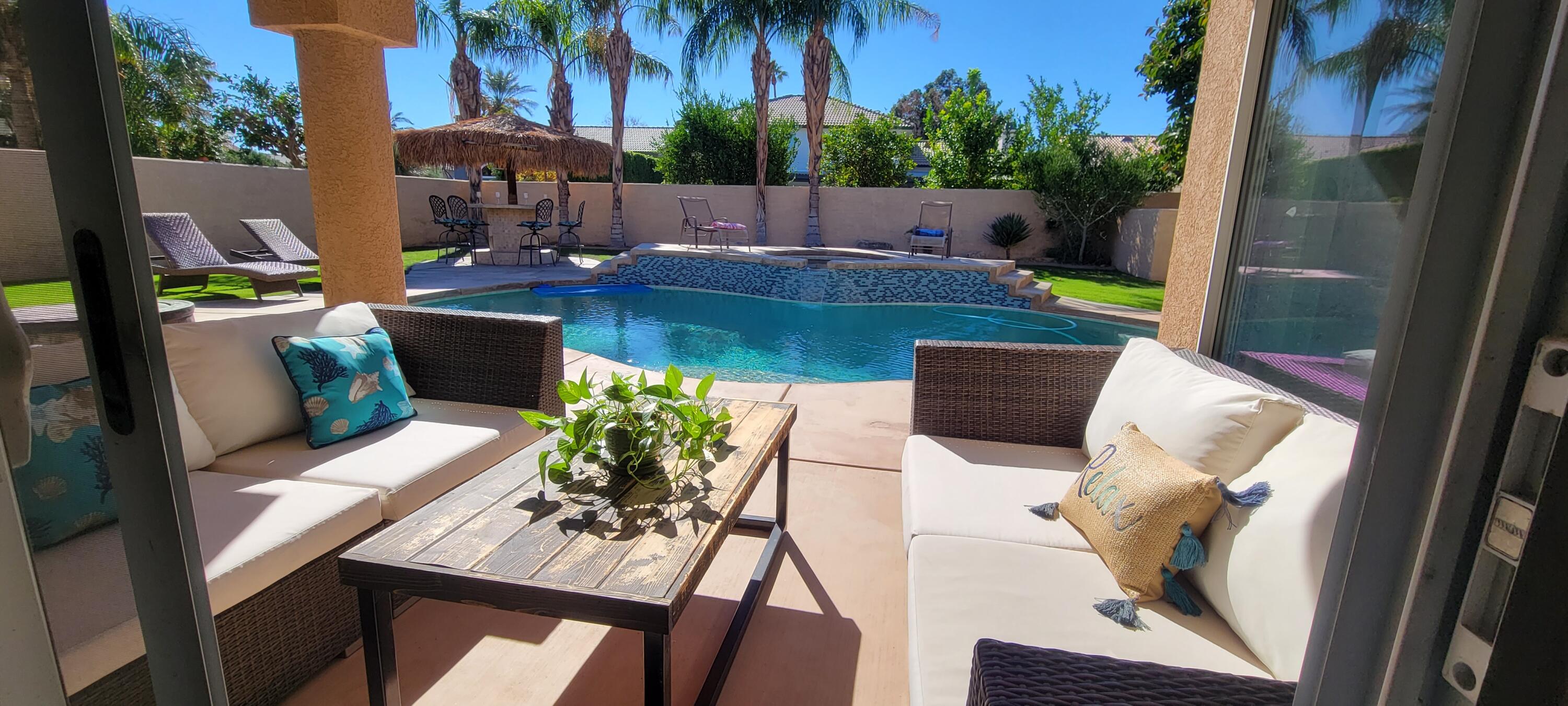 swimming pool view with a seating space