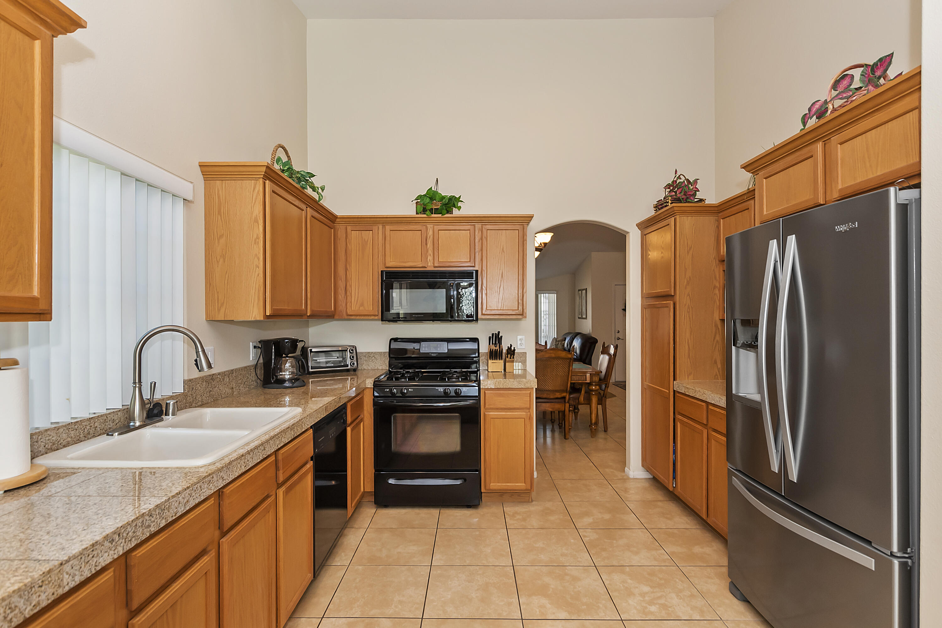 68945 Minerva Road Cathedral City, CA 92234 - Photo 17 of 42 a kitchen with stainless steel appliances granite countertop a refrigerator stove and sink