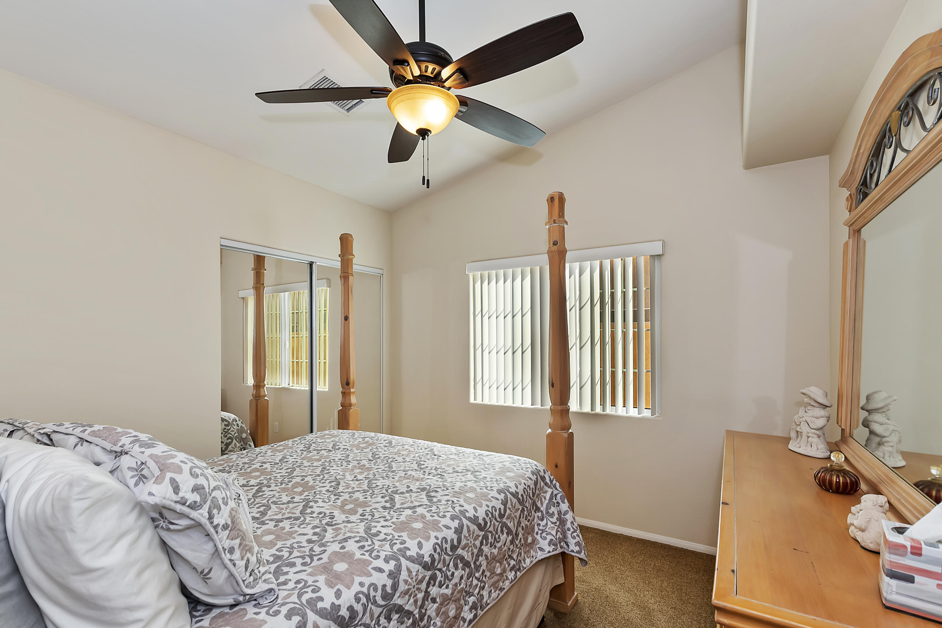 68945 Minerva Road Cathedral City, CA 92234 - Photo 22 of 42 a bedroom with a bed dresser and a window