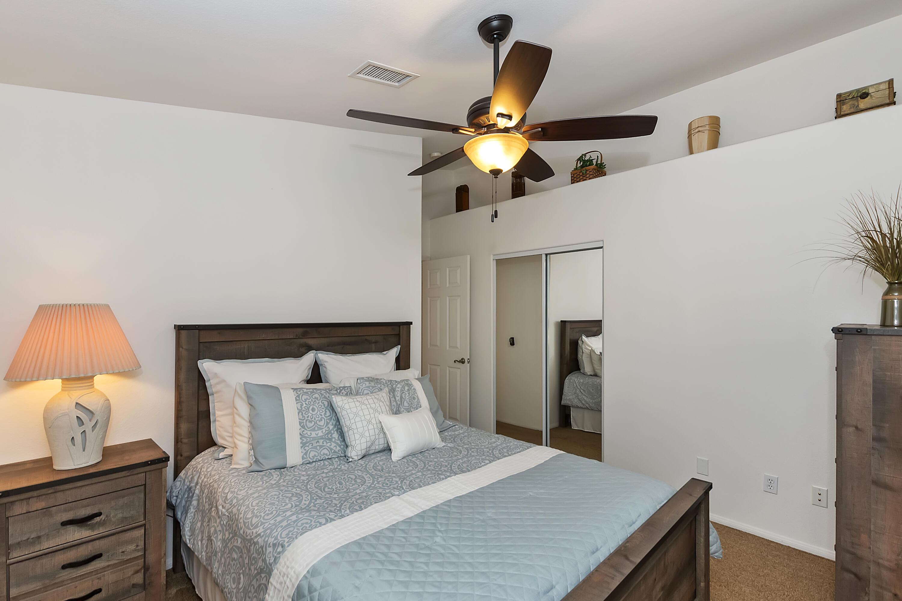 68945 Minerva Road Cathedral City, CA 92234 - Photo 24 of 42 a bedroom with a bed and a lamp on the dresser