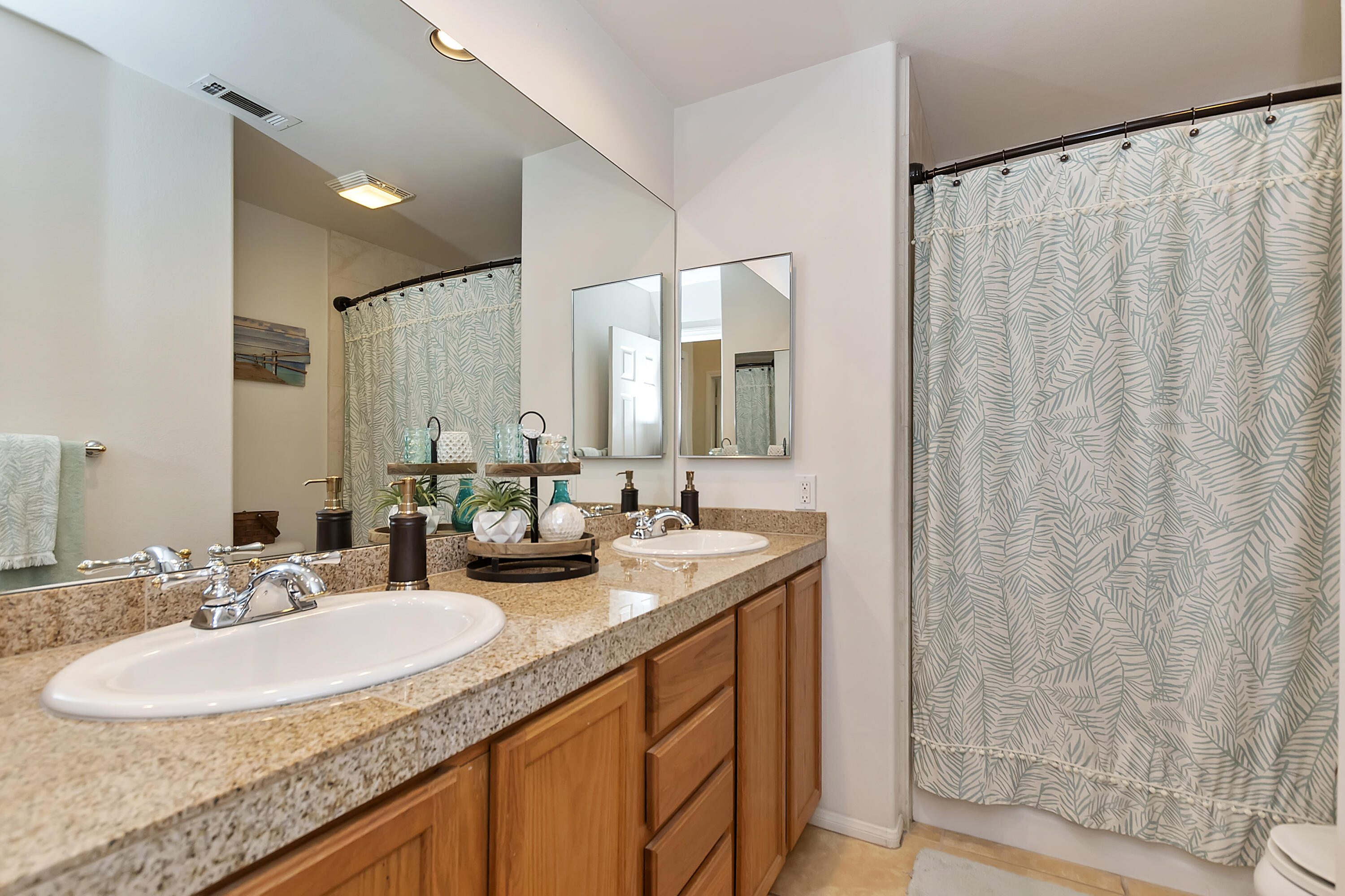 68945 Minerva Road Cathedral City, CA 92234 - Photo 25 of 42 a bathroom with double sink and a mirror