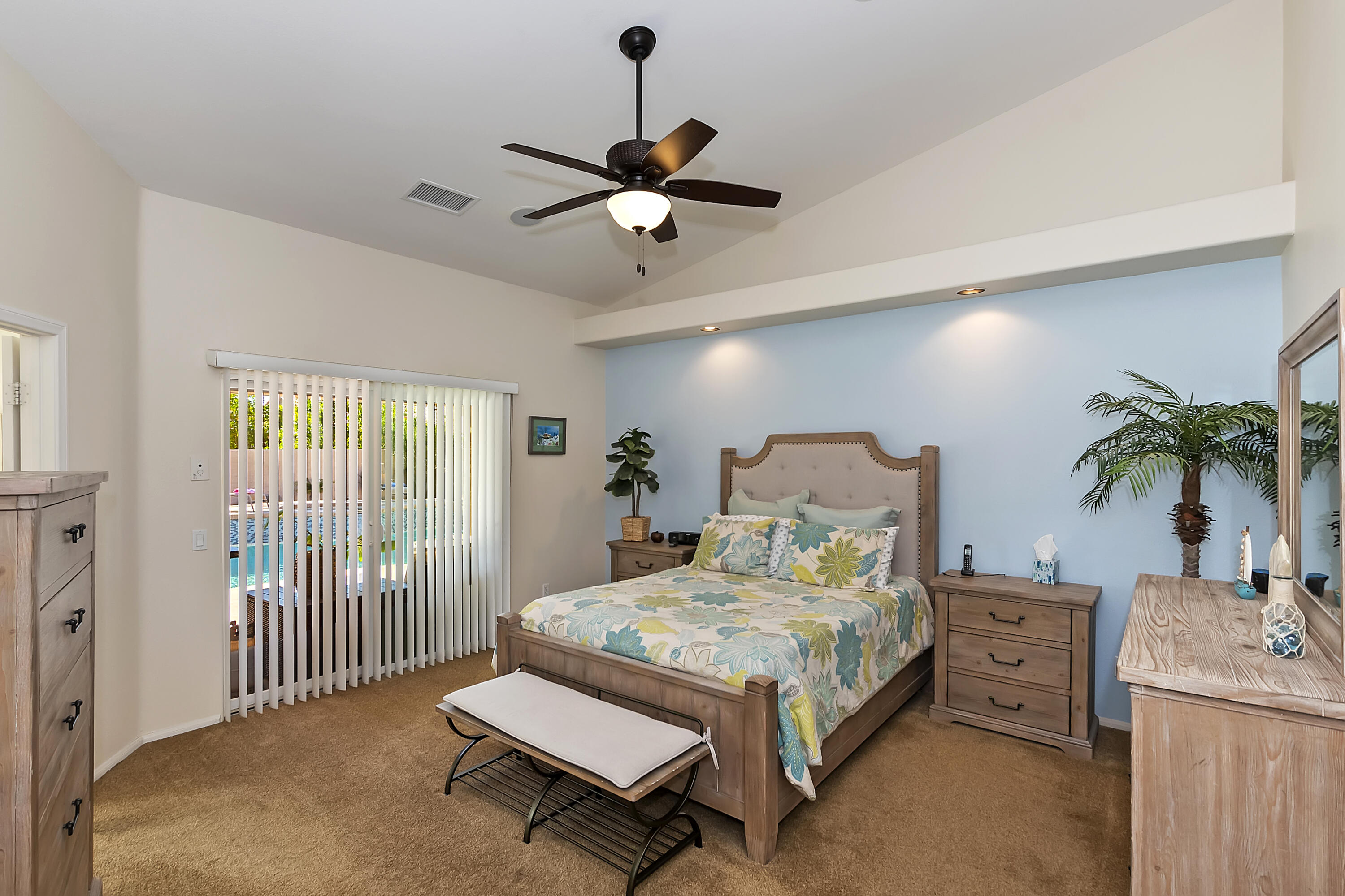 68945 Minerva Road Cathedral City, CA 92234 - Photo 27 of 42 a bed room with a bed and a chandelier