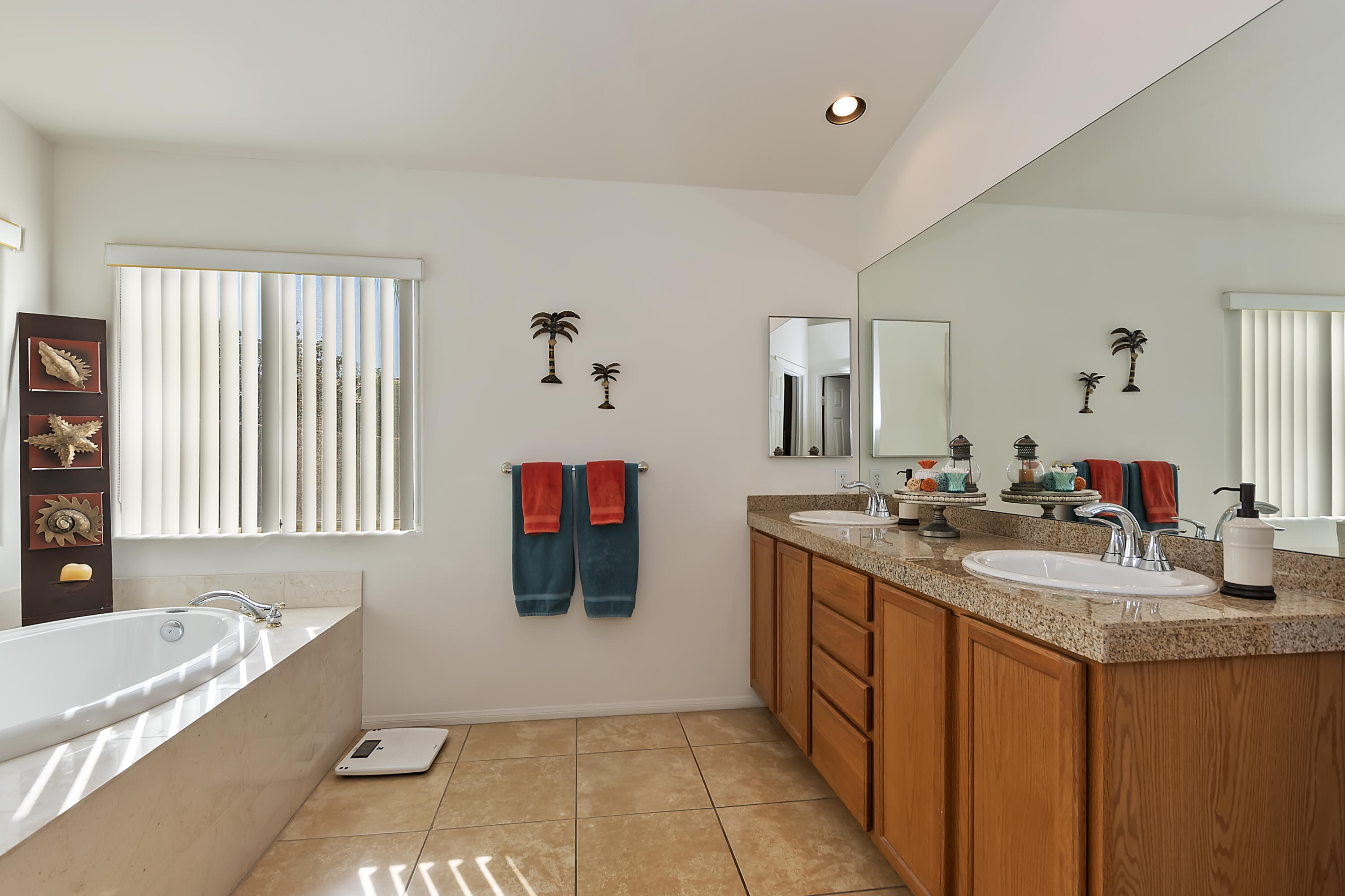 68945 Minerva Road Cathedral City, CA 92234 - Photo 30 of 42 a bathroom with a tub sink and mirror