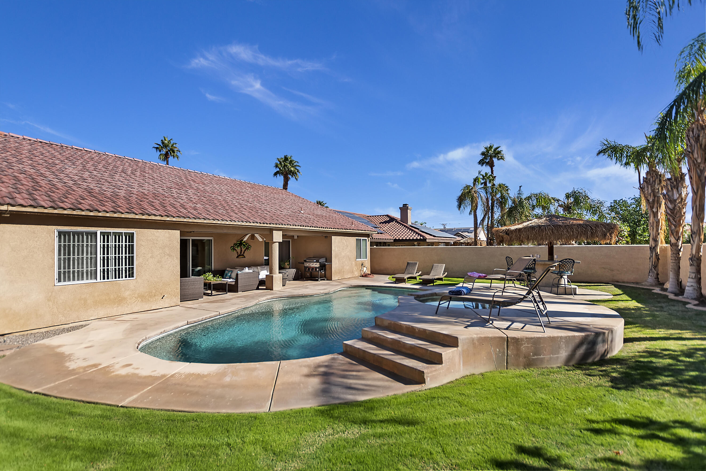 68945 Minerva Road Cathedral City, CA 92234 - Photo 36 of 42 a view of a house with backyard sitting area and swimming pool
