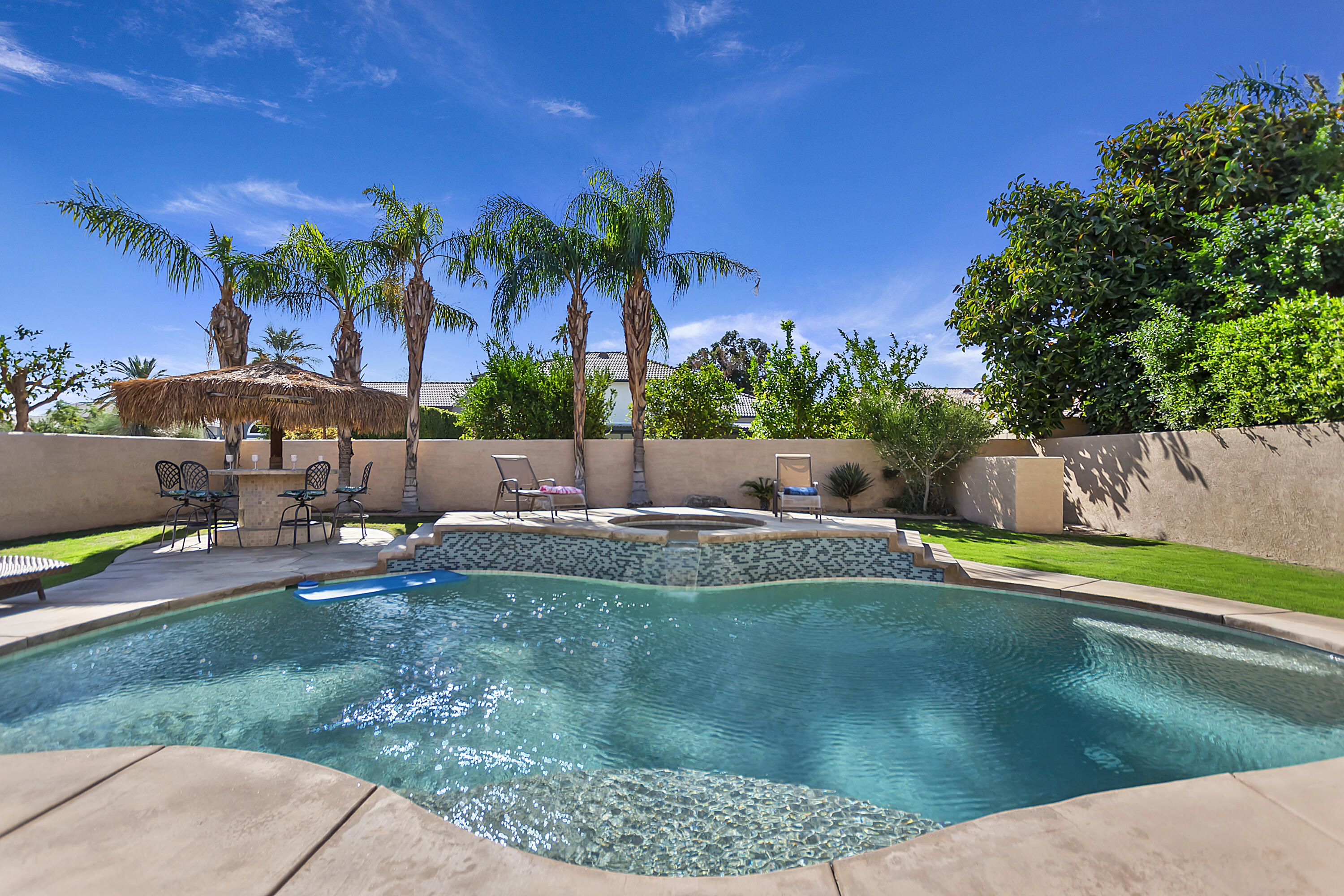 68945 Minerva Road Cathedral City, CA 92234 - Photo 40 of 42 a view of a swimming pool with a patio and a yard