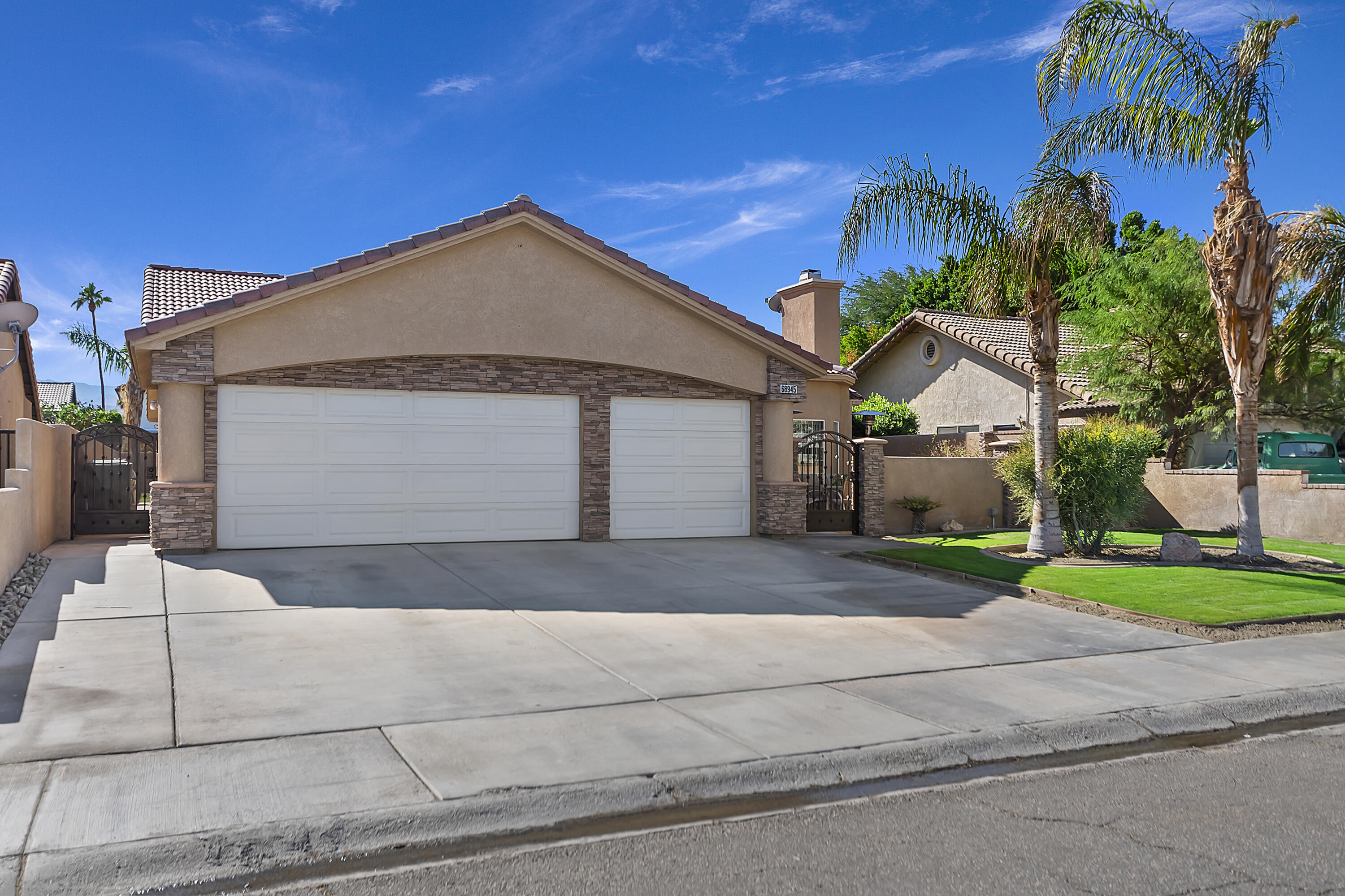 68945 Minerva Road Cathedral City, CA 92234 - Photo 42 of 42 a front view of a house with a yard and garage