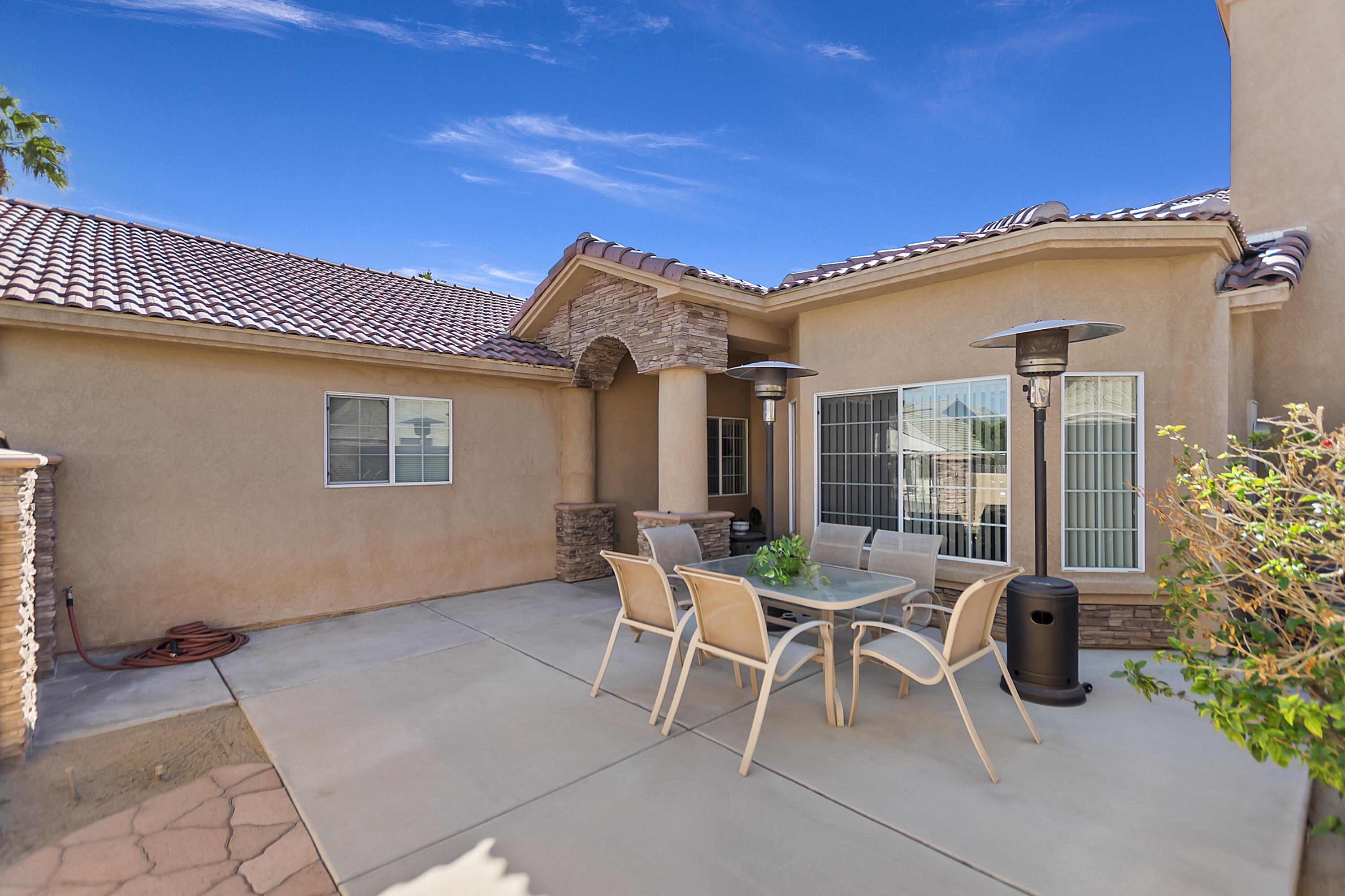 68945 Minerva Road Cathedral City, CA 92234 - Photo 6 of 42 a patio with a table and chairs and potted plants