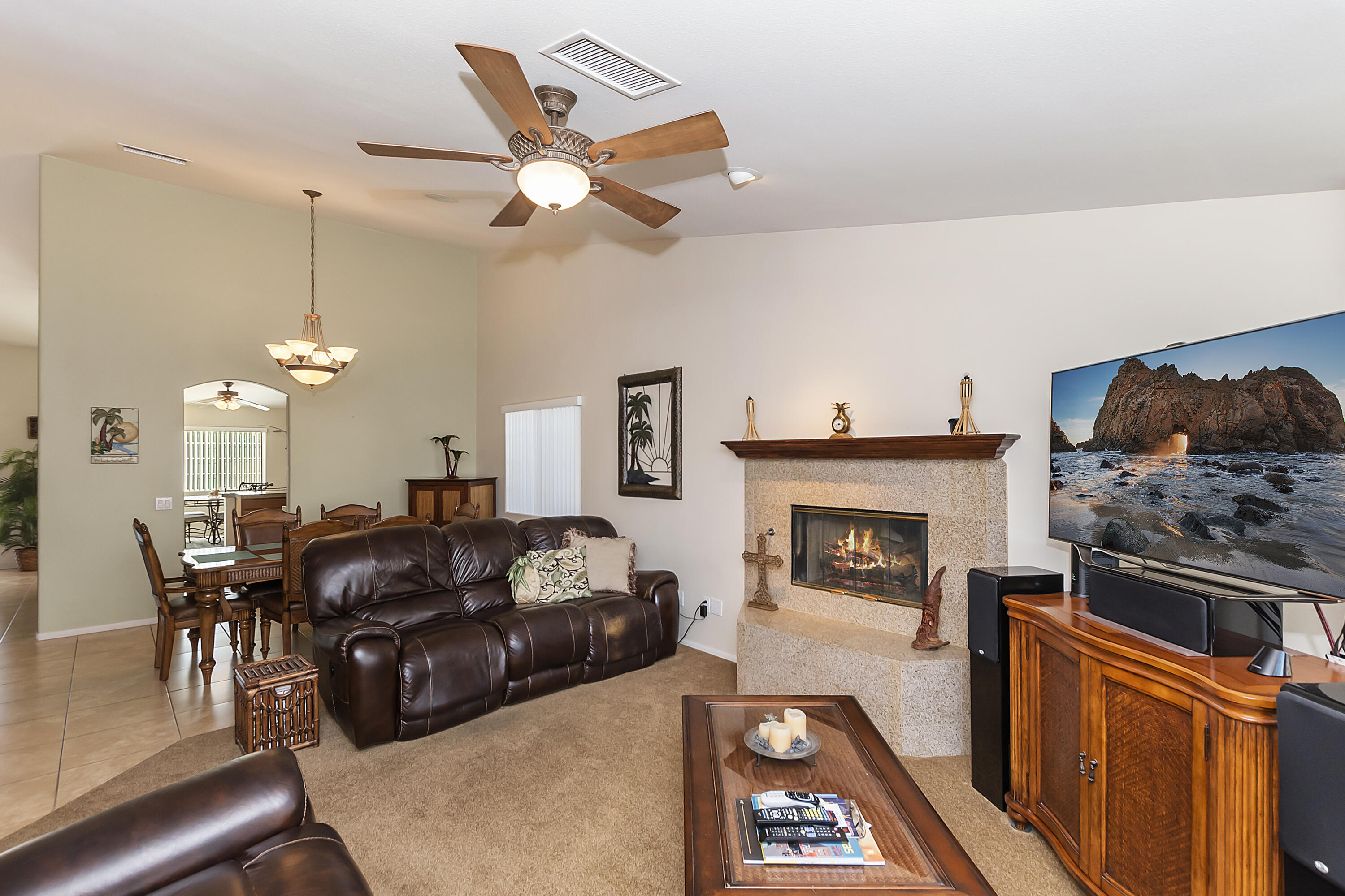 68945 Minerva Road Cathedral City, CA 92234 - Photo 10 of 42 a living room with furniture a fireplace and a chandelier