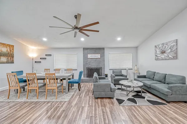 a living room with furniture and a wooden floor