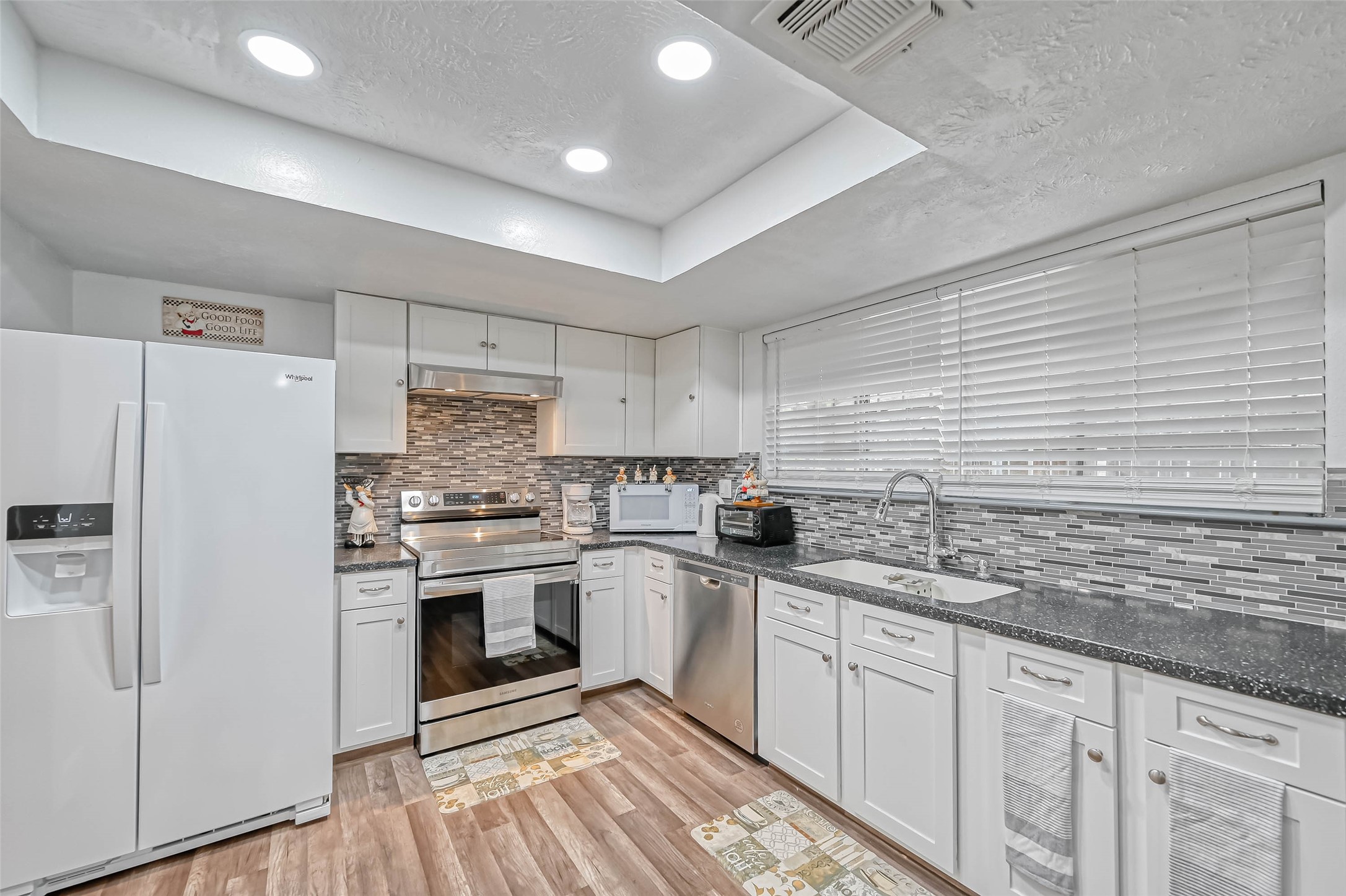 11618 Corona Lane Houston, TX 77072 - Photo 14 of 50 a kitchen with white cabinets stainless steel appliances and sink