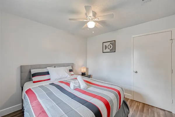 a bedroom with a bed and a chandelier