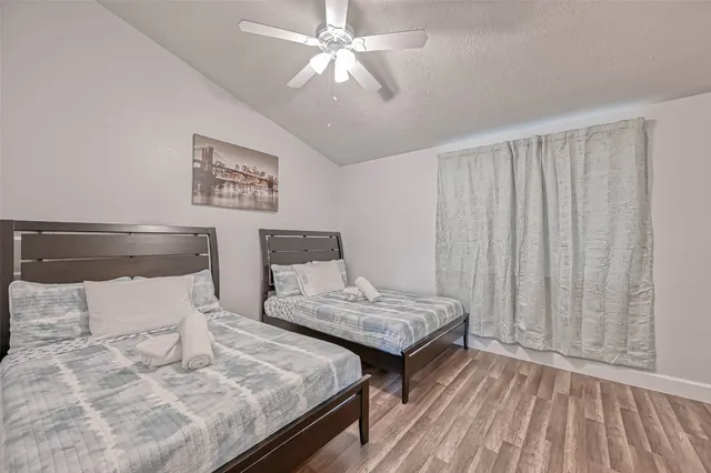 a bedroom with two beds and a chandelier