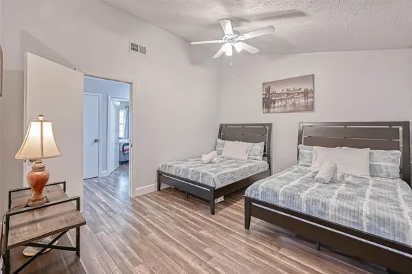 a bedroom with a bed and a lamp on table