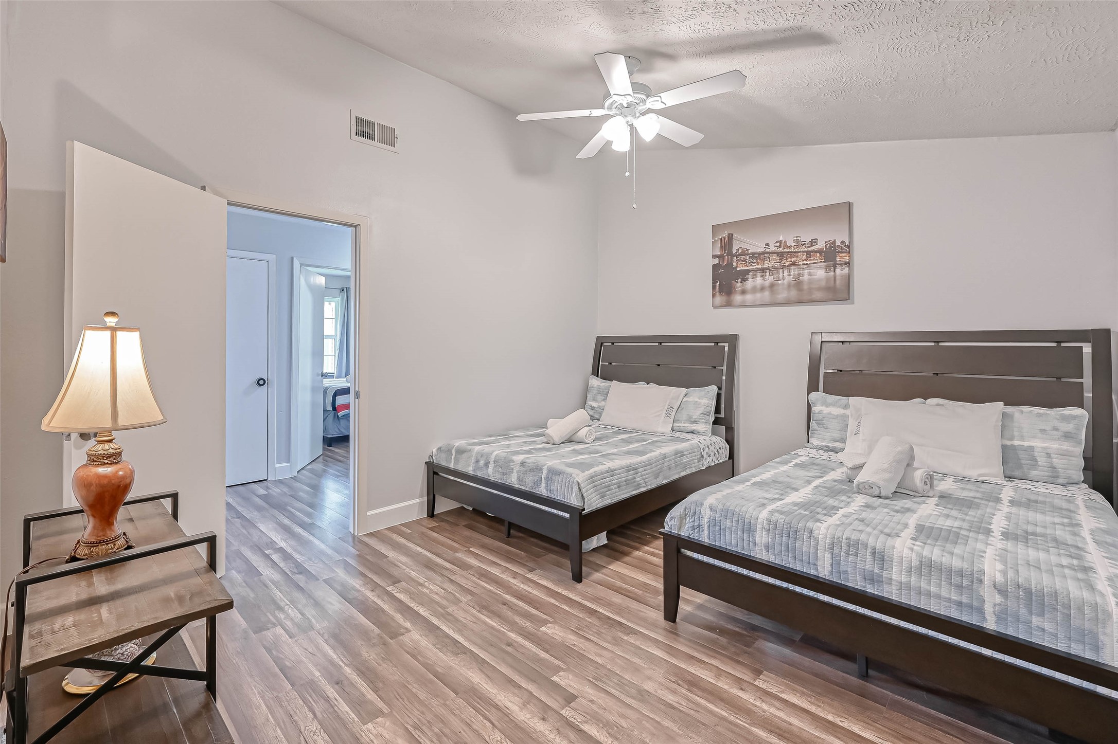 11618 Corona Lane Houston, TX 77072 - Photo 20 of 50 a bedroom with a bed and a lamp on table