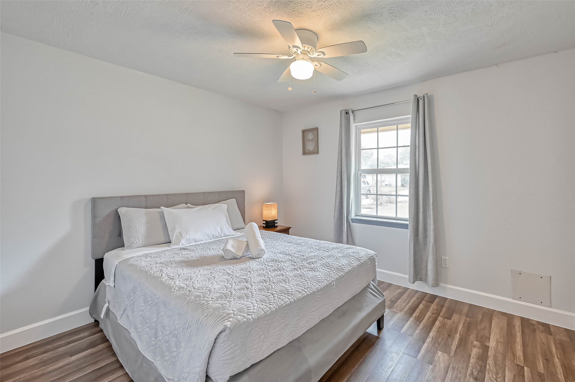 11618 Corona Lane Houston, TX 77072 - Photo 22 of 50 a bedroom with a large bed chandelier and a window