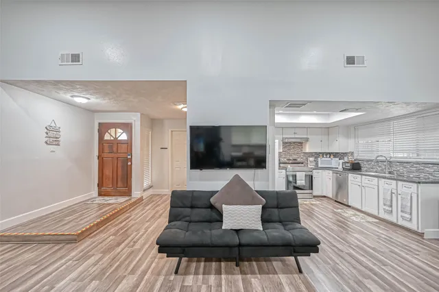a living room with furniture and a flat screen tv