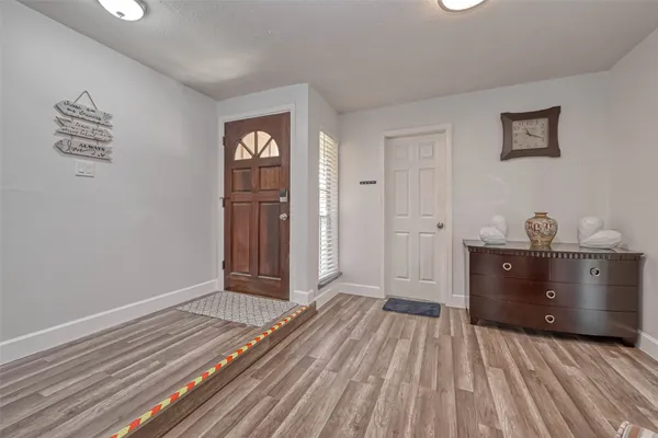 a bedroom with a bed and a view of wooden floor