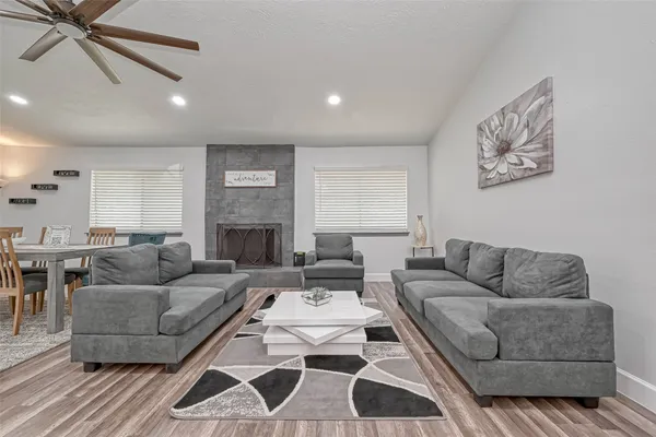 a living room with furniture a rug and a fireplace