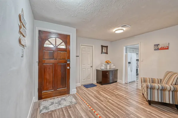 a bedroom with furniture and wooden floor