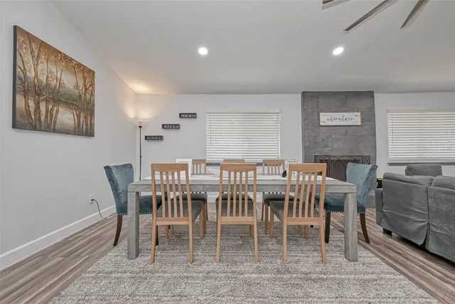 a kitchen with granite countertop a refrigerator oven a sink and white cabinets