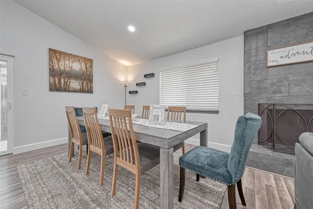 a large kitchen with cabinets wooden floor and stainless steel appliances