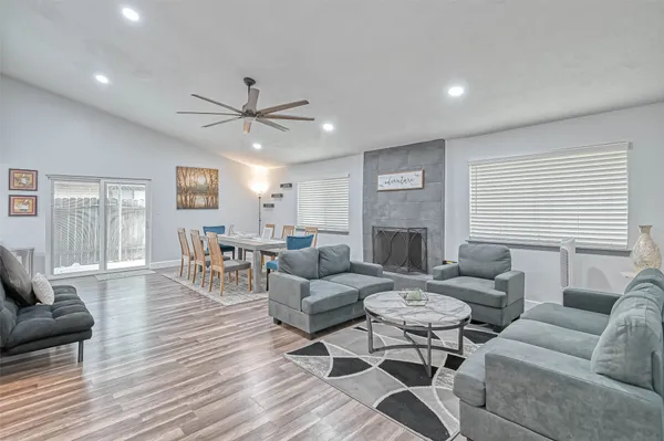 a living room with furniture a fireplace and a table