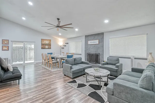 a living room with furniture a fireplace and a table