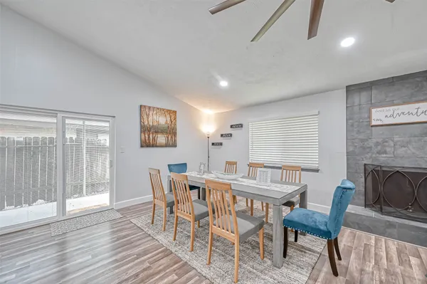 a dining room with furniture and wooden floor