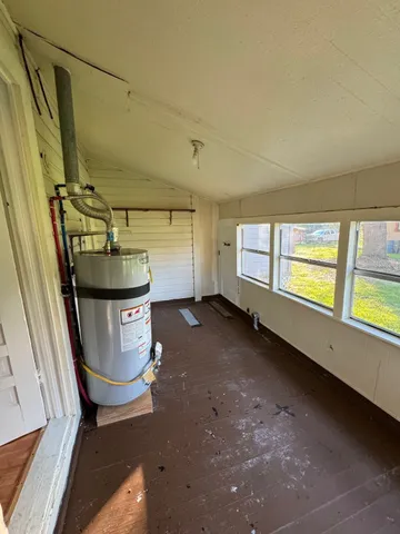 a room with water heater and a window