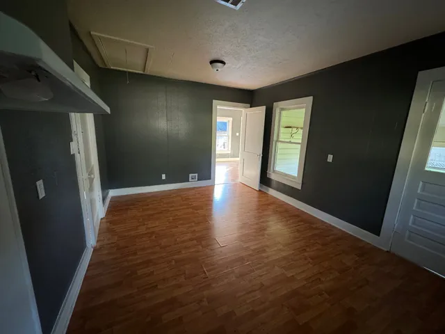 a view of hallway with stairs and wooden floor