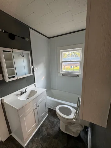 a bathroom with a toilet sink and mirror
