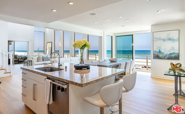 a kitchen with stainless steel appliances granite countertop a sink and wooden cabinets
