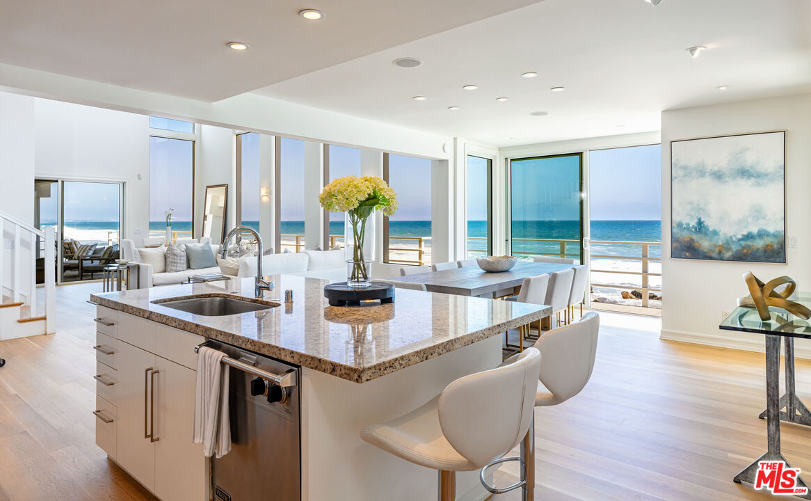 24314 Malibu Road Malibu, CA 90265 - Photo 15 of 41 a kitchen with stainless steel appliances granite countertop a sink and wooden cabinets