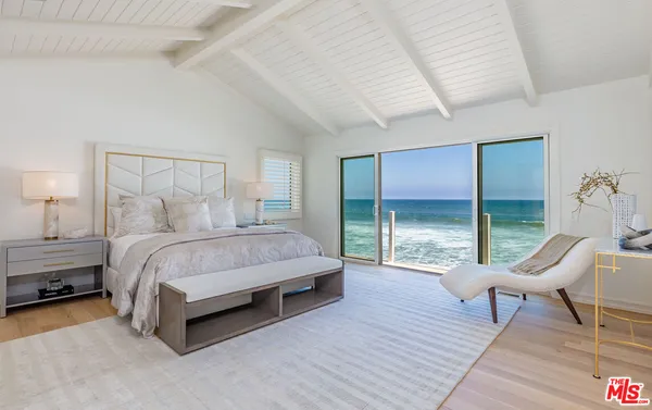 a spacious bedroom with a bed and a view of bedroom