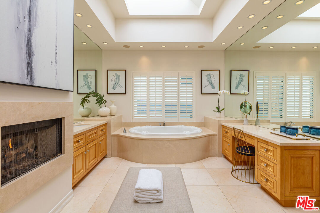 24314 Malibu Road Malibu, CA 90265 - Photo 26 of 41 a spacious bathroom with a granite countertop double vanity sink a bathtub and window