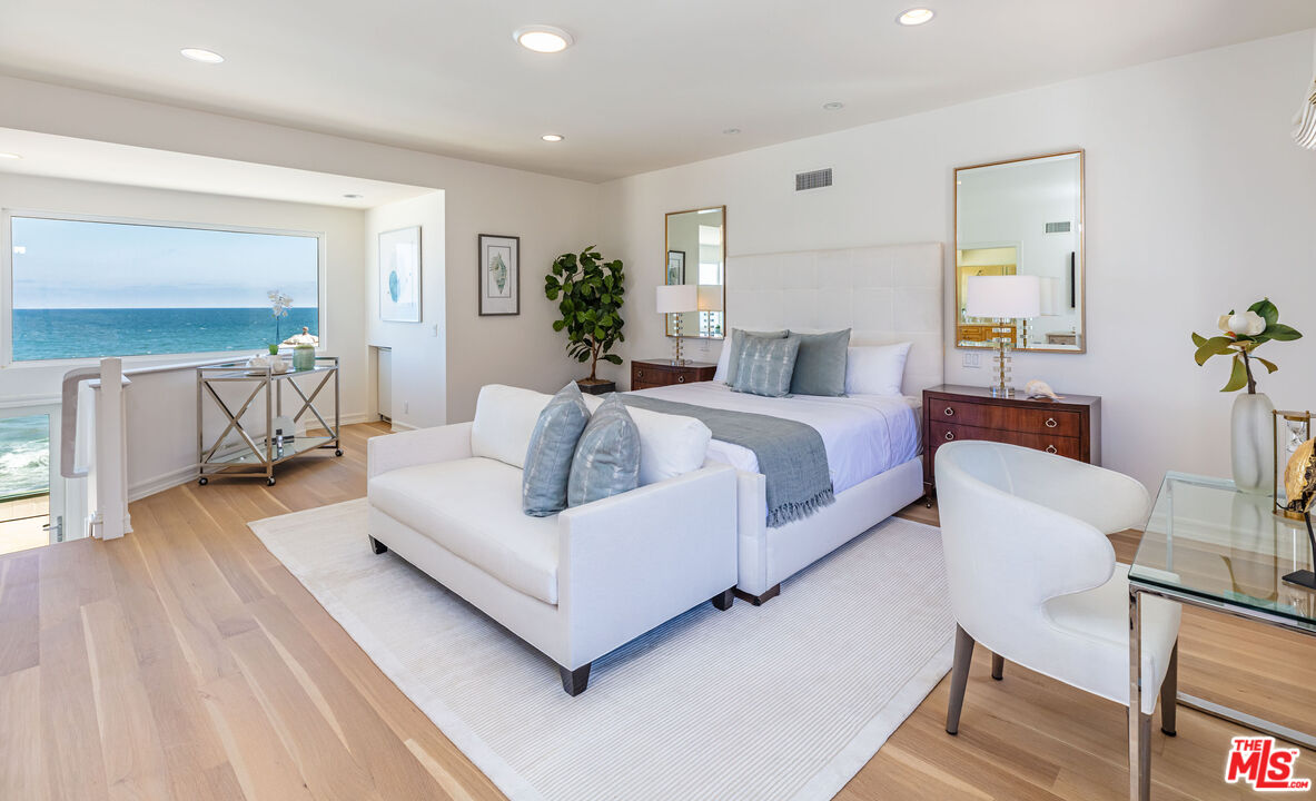 24314 Malibu Road Malibu, CA 90265 - Photo 29 of 41 a spacious bedroom with a bed and a couch
