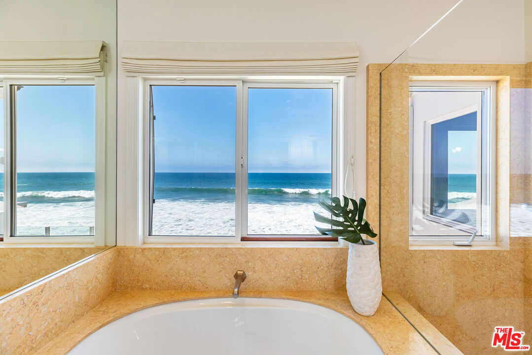 24314 Malibu Road Malibu, CA 90265 - Photo 33 of 41 a bathroom with a tub and window