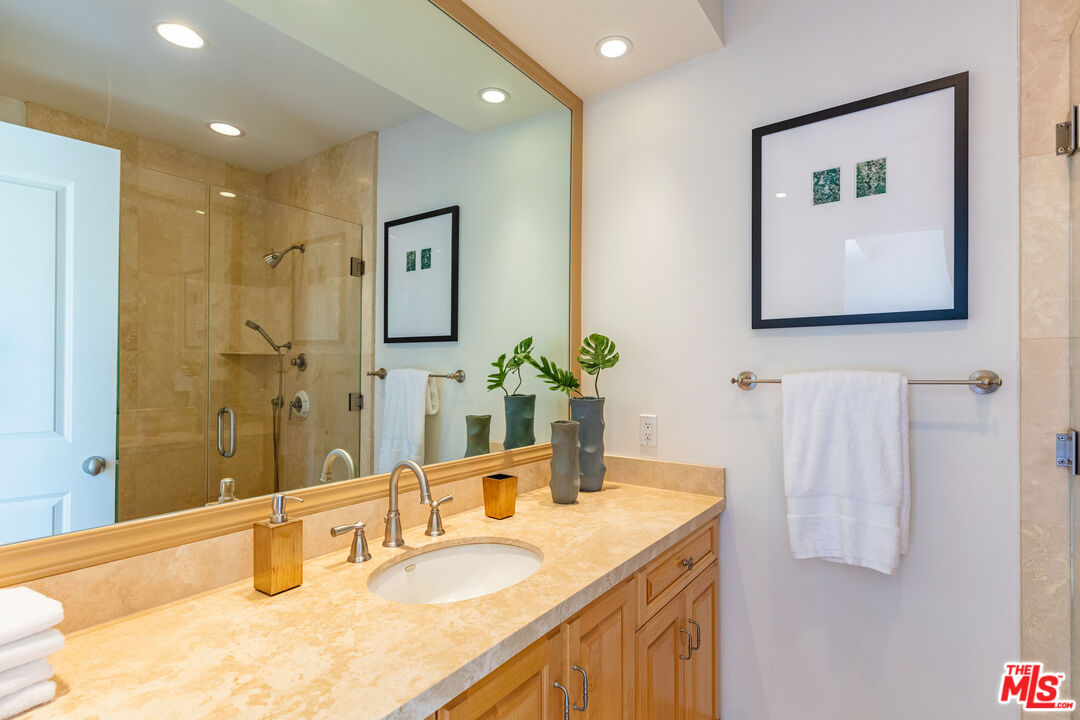 24314 Malibu Road Malibu, CA 90265 - Photo 35 of 41 a bathroom with a granite countertop sink and a mirror