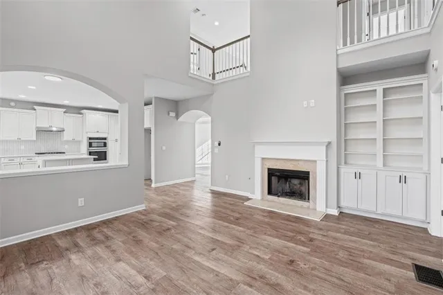 a view of a kitchen with wooden cabinet and a fireplace