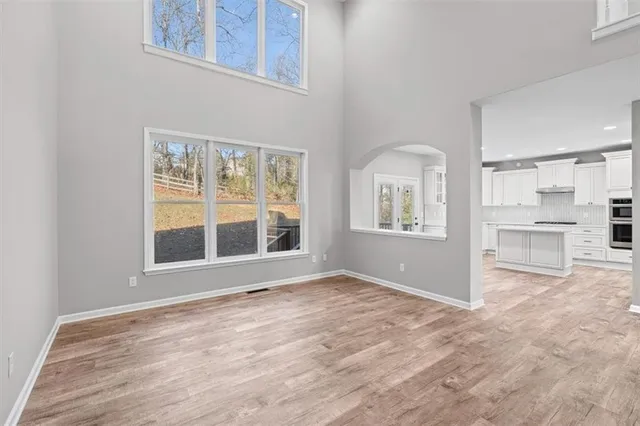 a large white kitchen with a sink a refrigerator and a stove