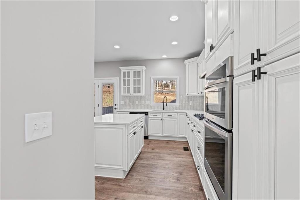 1038 Middlebrooke Drive Canton, GA 30115 - Photo 14 of 76 a large white kitchen with a sink a refrigerator and a stove