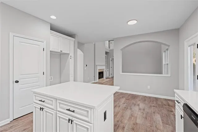 a view of a hallway with wooden floor and a chandelier